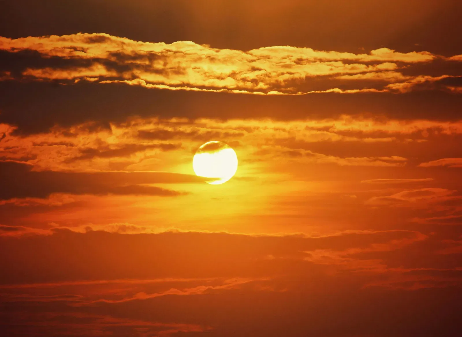 A view of the sunset amongst clouds.