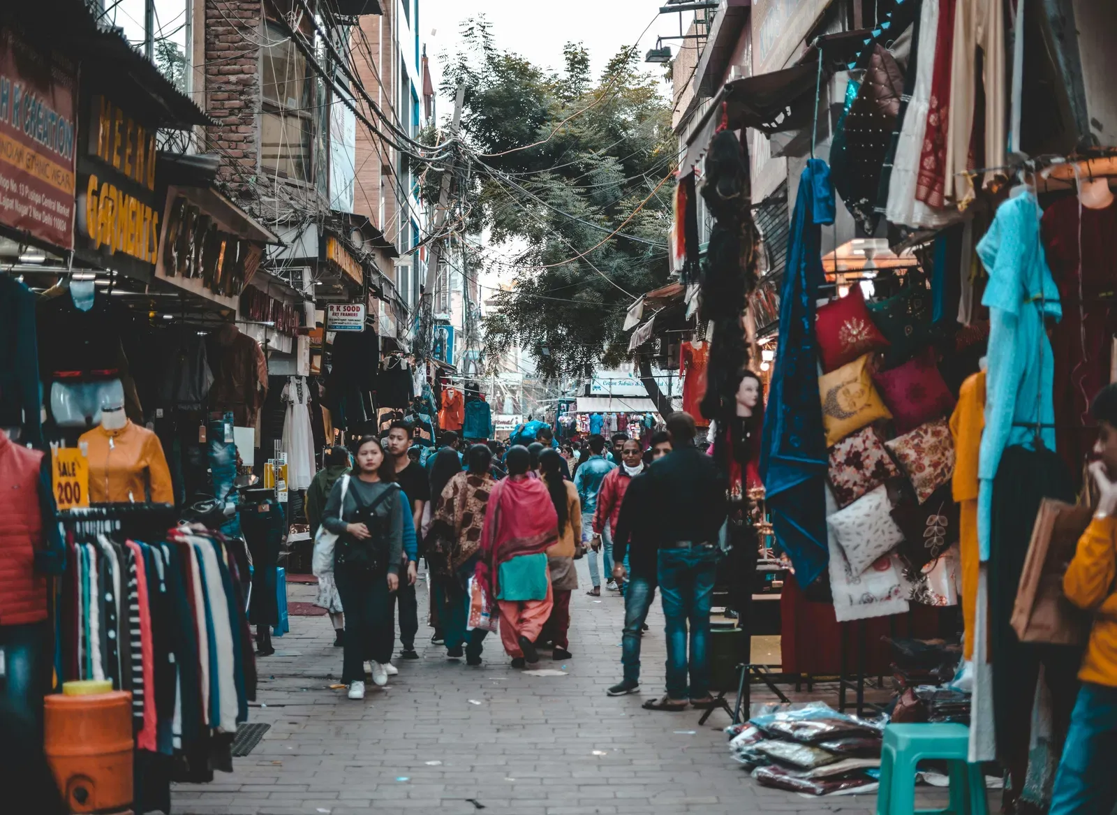 A local street market with people walking by during the day.