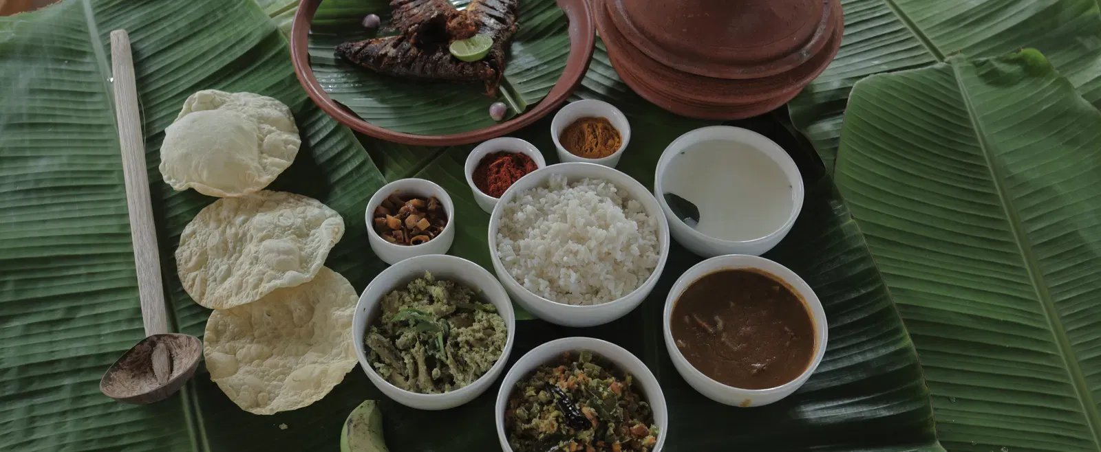 An assortment of various foot items placed on banana leaves at Samiira on Ashtamudi Lake.