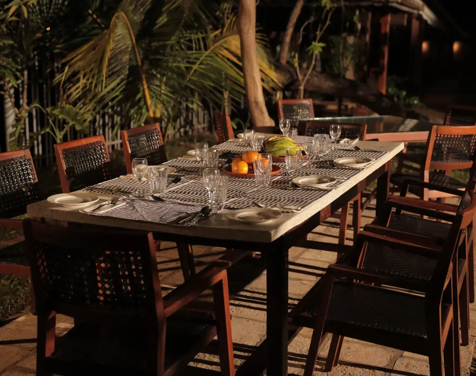 An outdoor seating area at Manger Cafe at Samiira on Ashtamudi Lake.