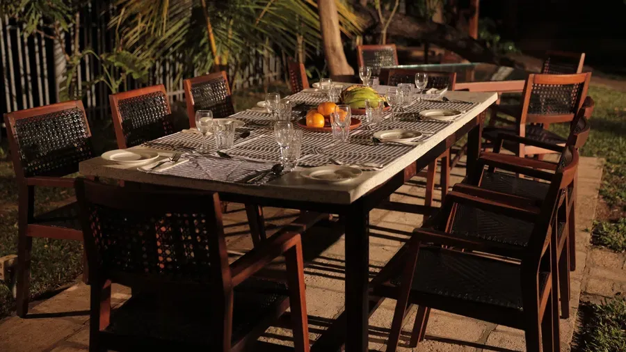 An outdoor seating area at Manger Cafe at Samiira on Ashtamudi Lake.