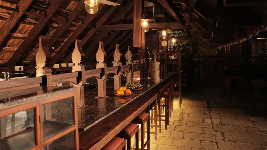 Seating area at the Manger Cafe with a wooden theme at Samiira on Ashtamudi Lake