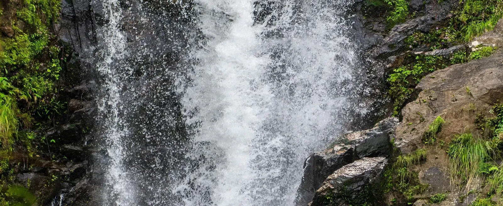 Scenic view of waterfall cascading through rocks.
