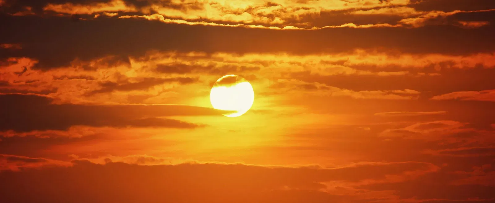 A view of the sunset amongst clouds.
