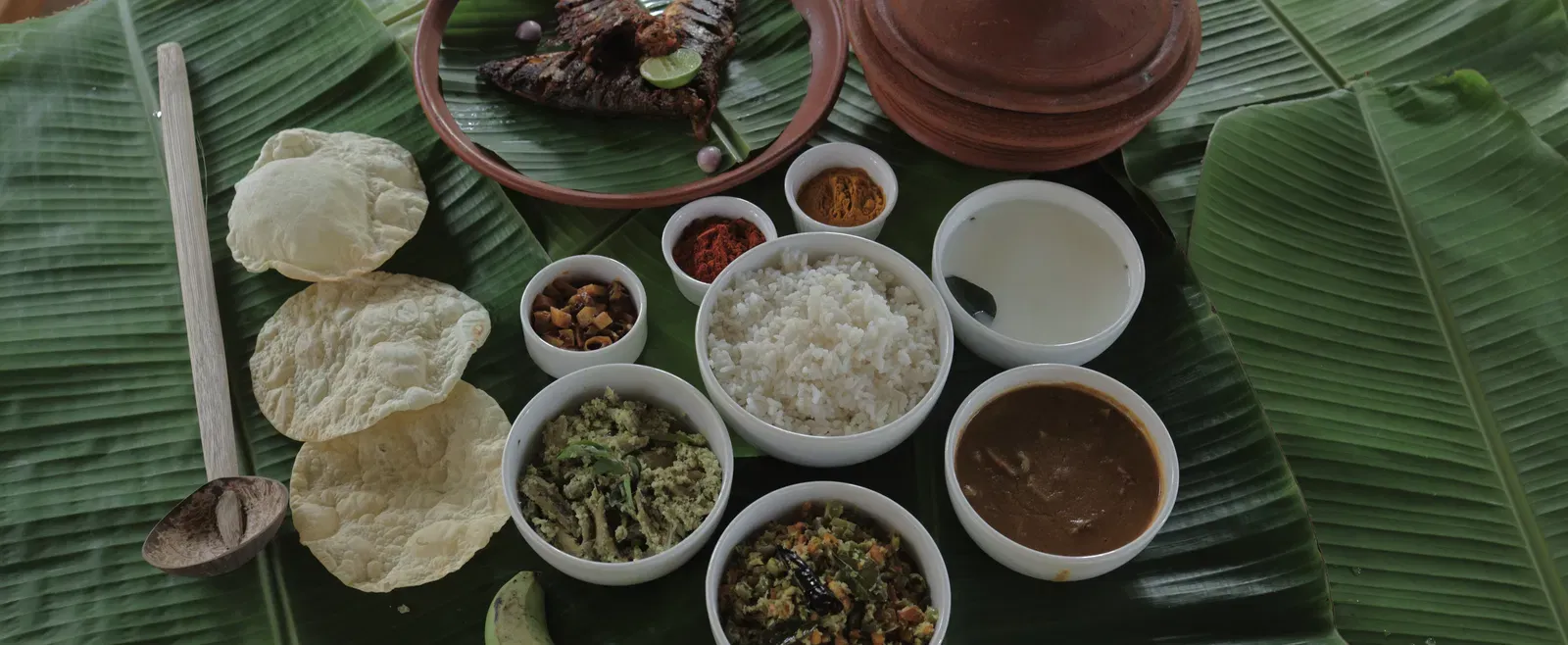 An assortment of various foot items placed on banana leaves at Samiira on Ashtamudi Lake.