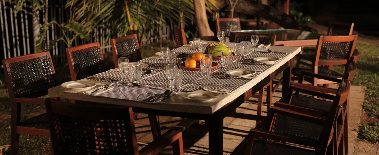 An outdoor seating area at Manger Cafe at Samiira on Ashtamudi Lake.