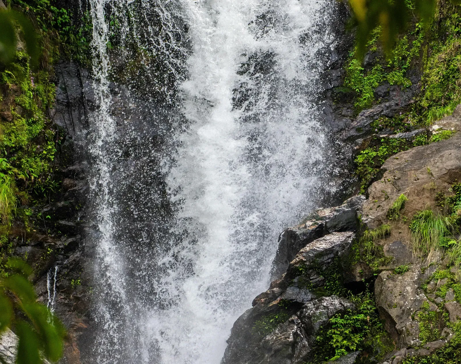 Scenic view of waterfall cascading through rocks.