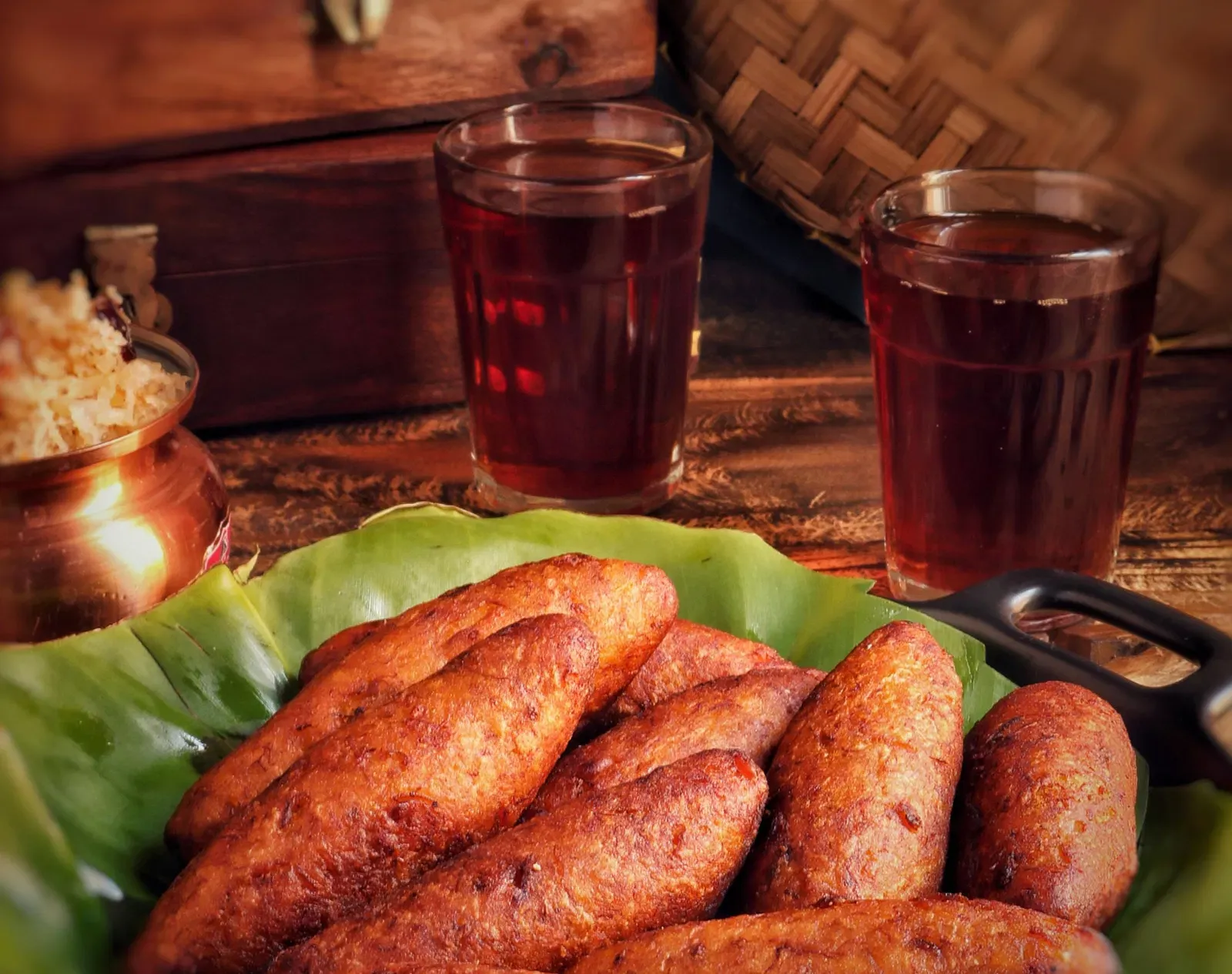 A Kerala cuisine placed on a table next to two glasses.